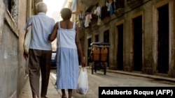 Ancianos caminan tomados del brazo por una calle de La Habana. (Adalberto Roque/AFP/Archivo)