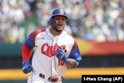 Yoan Moncada corre al plato tras anotar en un doble de dos carreras de su selección en el primer inning de su juego del Grupo A contra Taiwán. (AP Foto/I-Hwa Cheng)