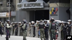 La policía y la Guardia Nacional custodian el Consejo Nacional Electoral (CNE) el día después de las elecciones presidenciales en Venezuela. (AP/Fernando Vergara)