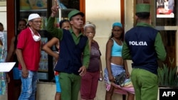 Policías controlan la multitud en una cola para comprar alimentos en La Habana. (YAMIL LAGE / AFP)