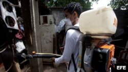 Un trabajador del Ministerio de Salud (MINSA) realiza labores de fumigación en un barrio de Managua (Nicaragua). 