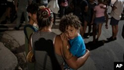 Una madre carga a su niño en brazos durante una protesta pacífica, en La Habana, Cuba, este sábado 1ro de octubre. (AP/Ramon Espinosa)