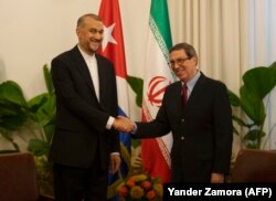 El canciller cubano Bruno Rodríguez saluda a su homólogo iraní de visita en la isla, Hossein Amir-Abdollahian. (Yander Zamora/POOL/AFP)