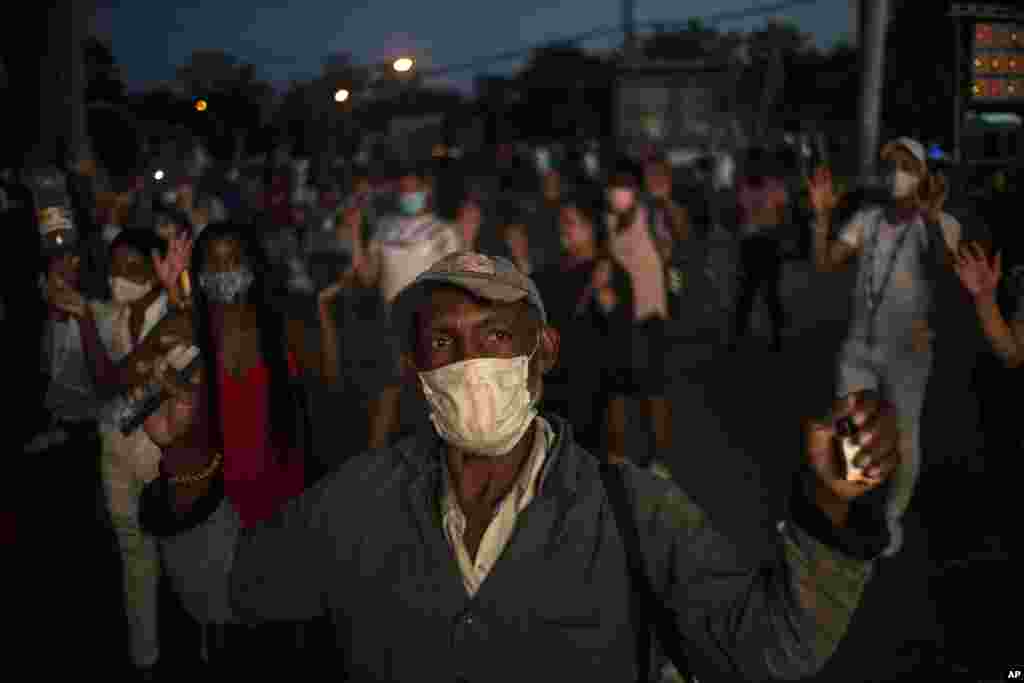 Seguidores de San Lázaro, con máscaras, en medio de la pandemia de coronavirus, rezan durante la peregrinación al santuario del santo para su fiesta anual, en el barrio El Rincón de Santiago de Las Vegas. (AP Photo/Ramon Espinosa)