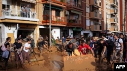 Voluntarios y vecinos limpian la calle el 1 de noviembre de 2024, después de que una inundación devastara la localidad de Paiporta, en la región de Valencia, al este de España. (Foto by Manaure Quintero / AFP)