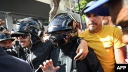 Venezuelan opposition leader Maria Corina Machado (C) leaves after delivering a speech during a demonstration called by the opposition on the eve of the presidential inauguration, in Caracas on January 9, 2025.