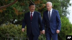 El presidente de EEUU, Joe Biden, y el presidente de China, Xi Jinping, caminan en los jardines de Filoli Estate, en Woodside, California, el miércoles 15 de noviembre de 2023. (Doug Mills/The New York Times via AP, Pool).