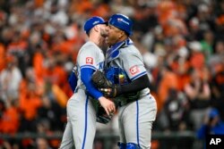 Lucas Erceg (izquierda) y el venezolano Salvador Pérez, de los Reales de Kansas City, festejan el triunfo en la serie de comodines sobre los Orioles de Baltimore, el miércoles 2 de octubre de 2024 (AP Foto/Nick Wass)