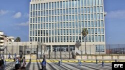 Periodistas y curiosos aguardan frente a la Embajada de Estados Unidos en Cuba.